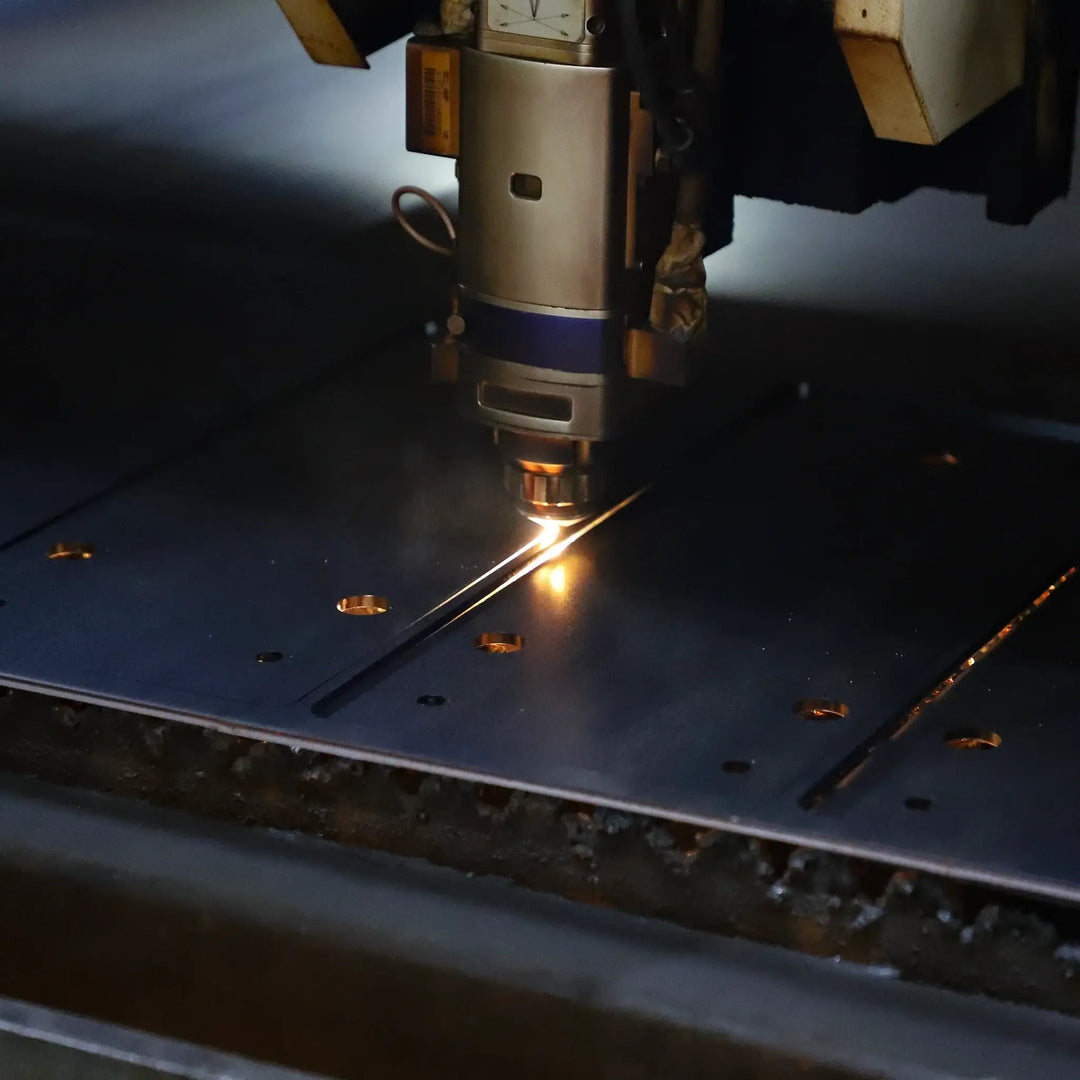 Laser cutting machine in action on metal, precision manufacturing process.