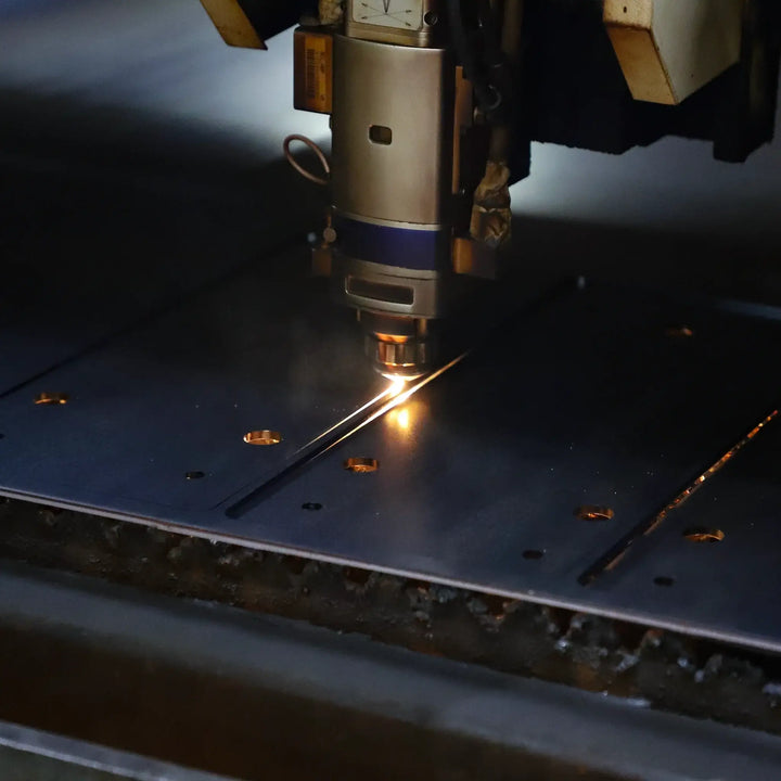 Laser cutting machine in action on metal, precision manufacturing process.
